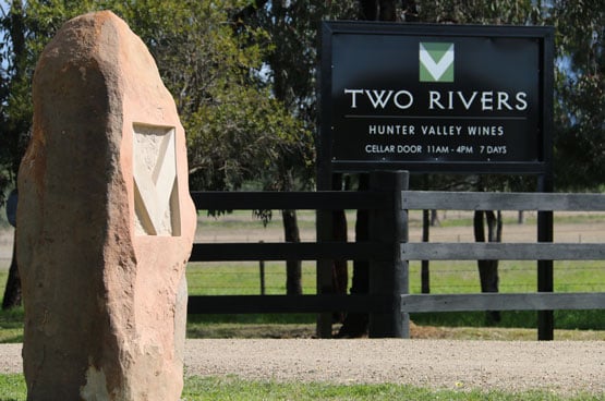 The sandstone gatepost and the Two Rivers sign at the entry on Yarrawa Road